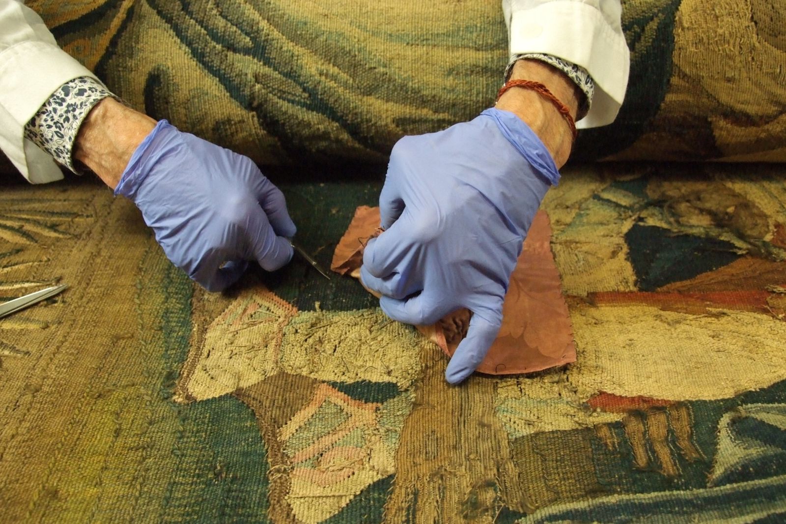 Retrait d’une ancienne restauration sur une tapisserie